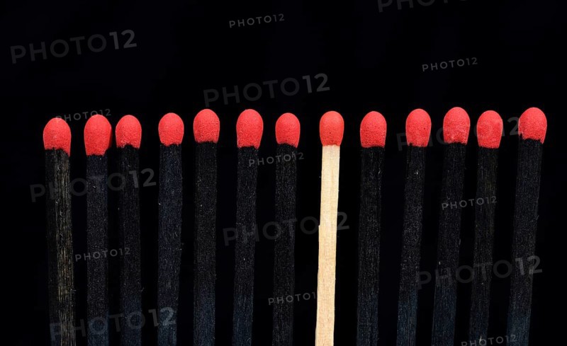 A bright match among several black matches
