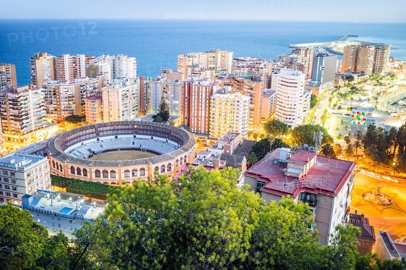 Malaga bullring surrounded by residential buildings next to the sea