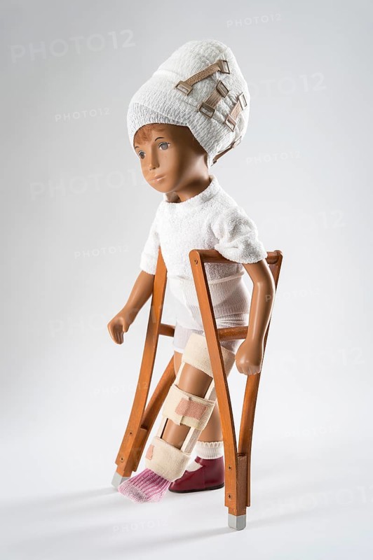 Doll with bandage on head