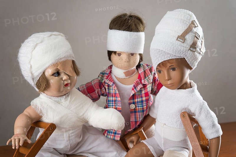 Three dolls sitting