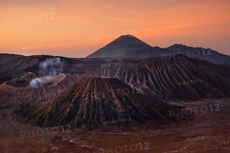 Volcanic pipes with smoking volcano Gunung Bromo
