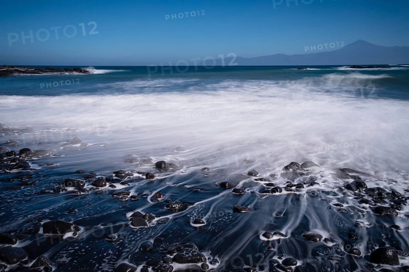 Black pebble beach with wave hem