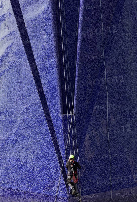 Climber on the Trencadi facade of the Agora