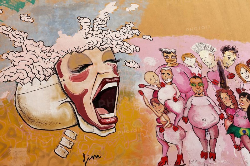 Skull with mask tied on female screams at a group of people