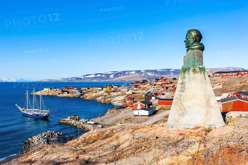 East Greenland town Ittoqqortoormiit with view to the harbour and the statue of Einar Mikkelsen