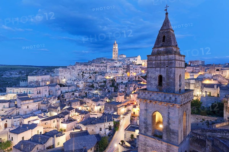 View of Church of San Pietro Barisano and Sasso Barisano historic centre with cathedral at dusk