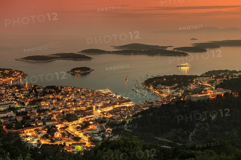 Town view Hvar with harbour and Pakleni islands at sunset