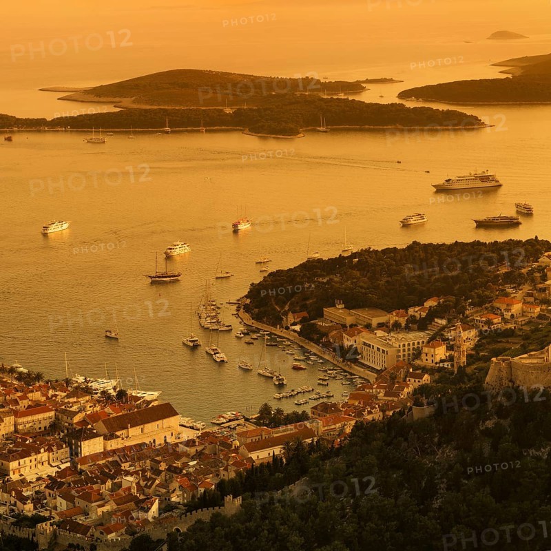 Town view Hvar with harbour and Pakleni islands at sunset