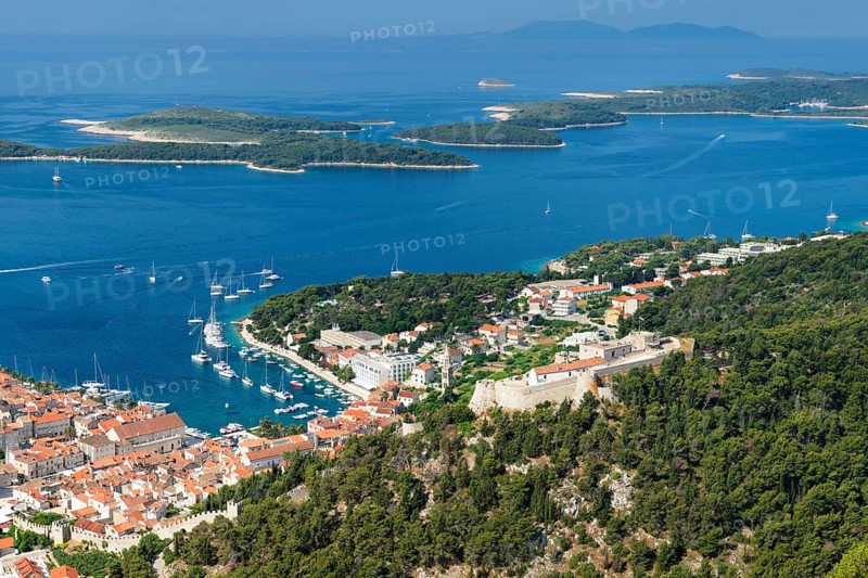 Overview of old town with harbour and fortress and Pakleni islands
