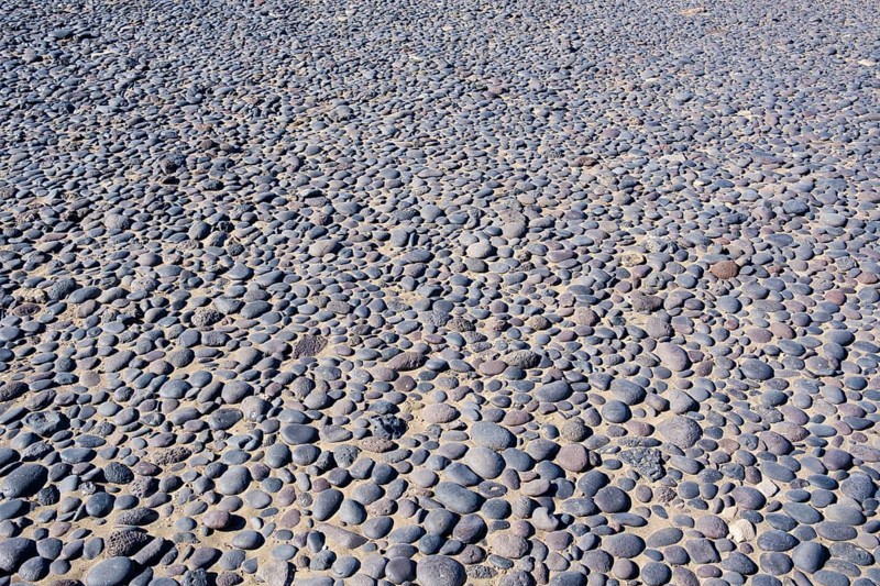 Round black pebbles on the beach