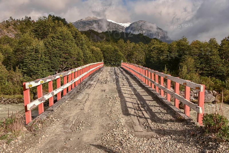 Simple wooden bridge at Mirador Glaciar Exploradores over Rio Exploradores at Puerto Rio Tranquilo
