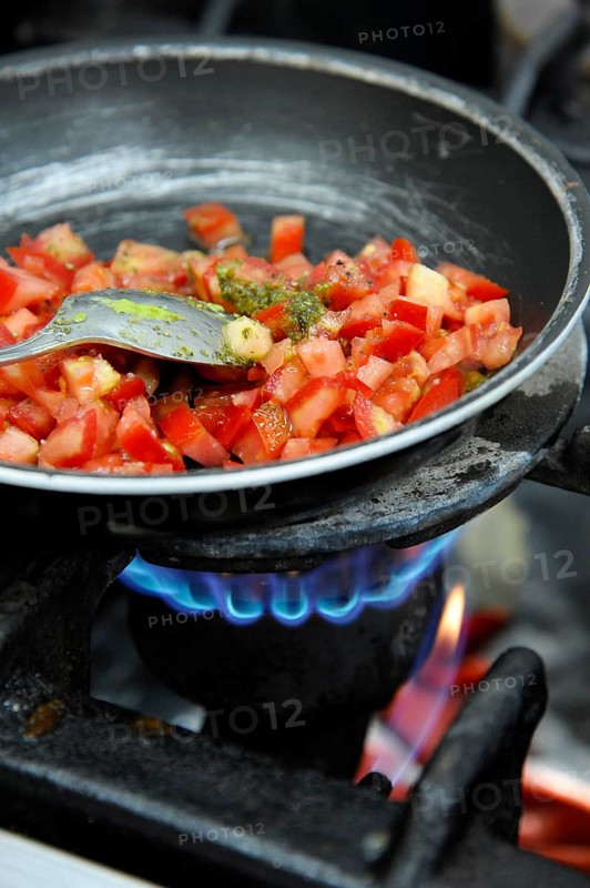 Diced tomatoes stewing in a pan