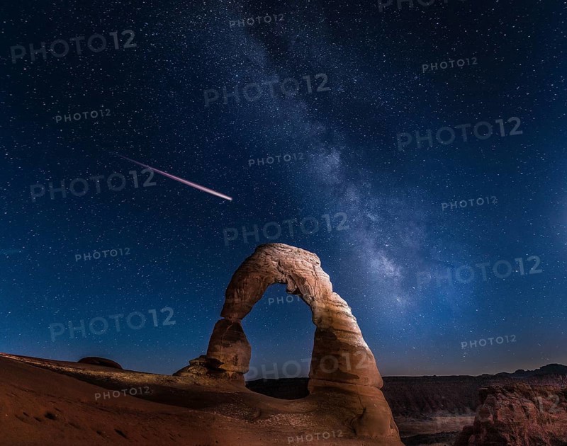 Natural Arch Delicate Arch with Milky Way and shooting star at night