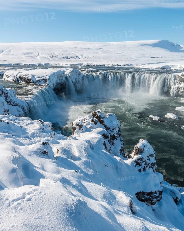 Gooafoss Waterfall in winter with snow and ice