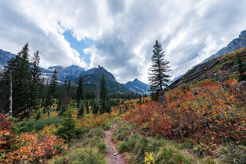 Hiking trail through mountain landscape in autumn to Upper Two Medicine Lake