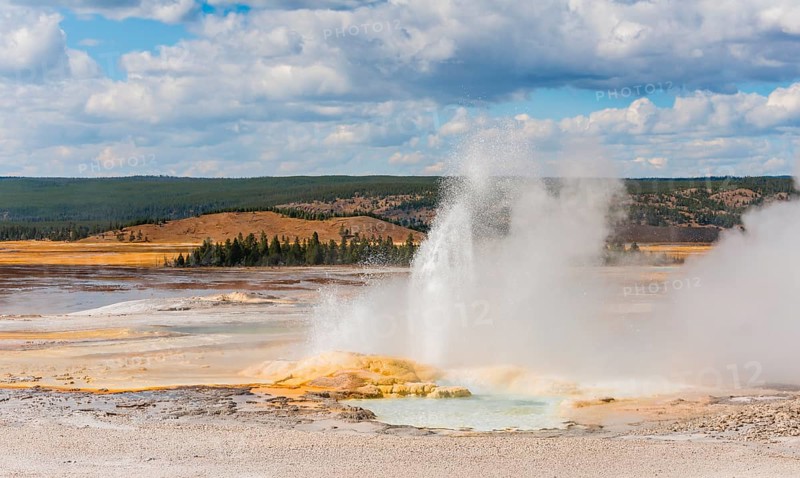 Steaming geyser with water fountain