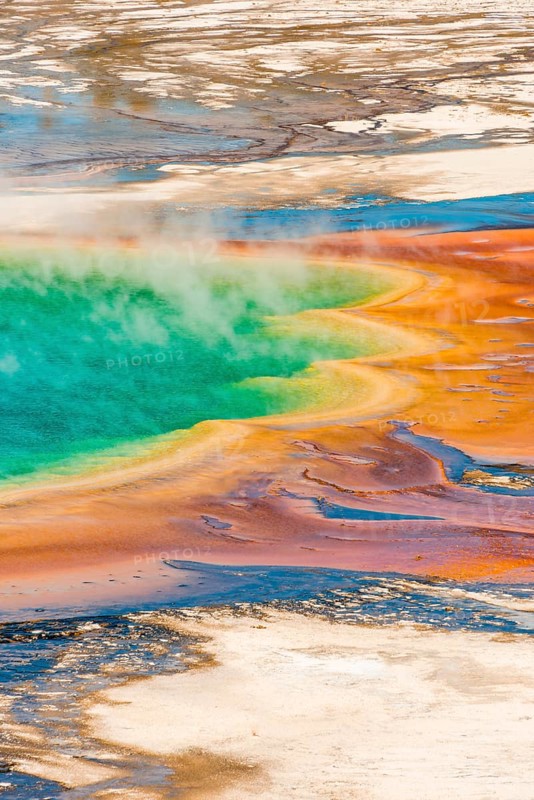 Colored mineral deposits at the edge sr steaming hot spring