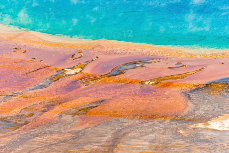 Colored mineral deposits at the edge sr steaming hot spring