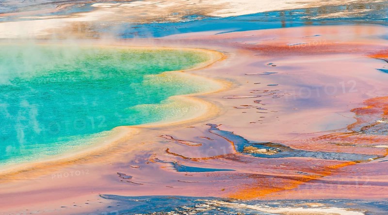 Colored mineral deposits at the edge sr steaming hot spring