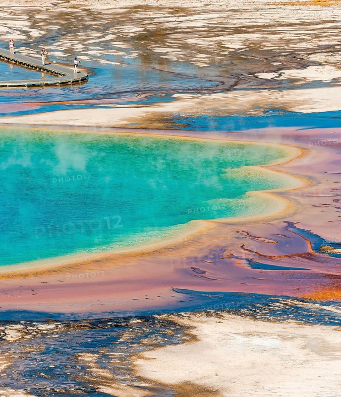 Colored mineral deposits at the edge sr steaming hot spring