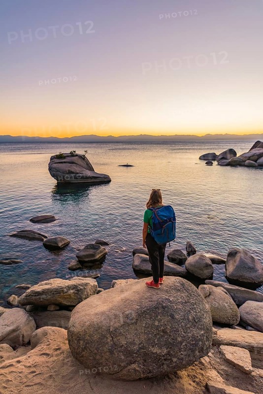 Young woman standing on the shore of Lake Tahoe