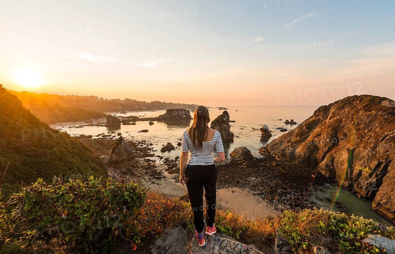Young woman looking into the sunrise