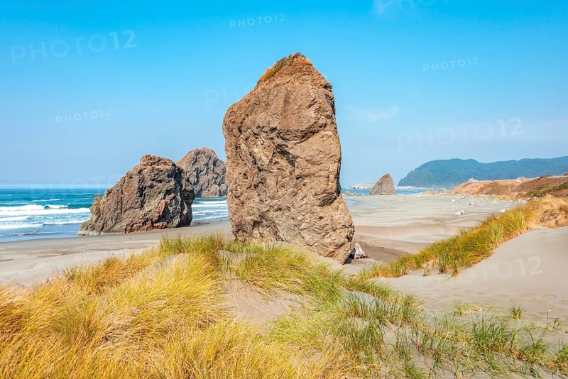 View over sandy beach with large monolithic rocks