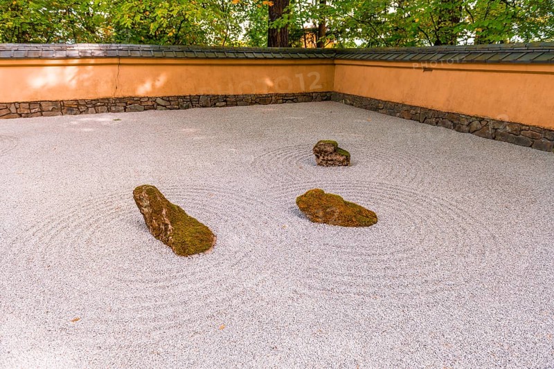 Japanese garden with gravel surface as symbol for water