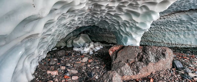 Entrance of an ice cave of a glacier