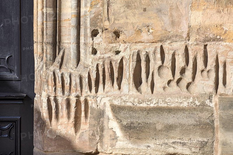 Medieval sharpening grooves on a church wall
