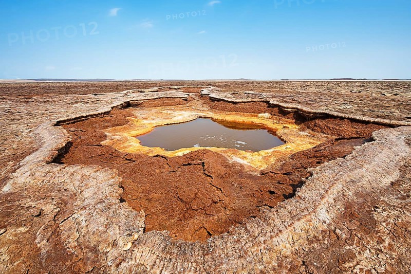Salt lake with geothermal spring and petrified salt crystals