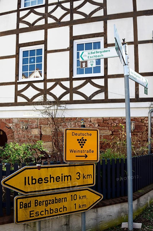 Road sign German Wine Route in front of half-timbered house in Leinsweiler