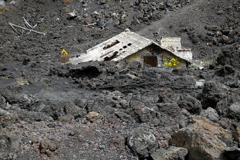 House covered with lava on the slopes of Mount Etna