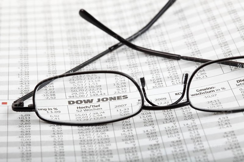 Reading glasses lying on newspaper