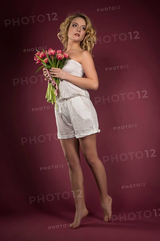 Young woman posing with bouquet of flowers