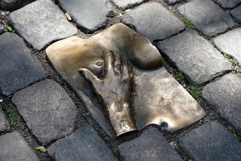 Bronze relief in cobblestone