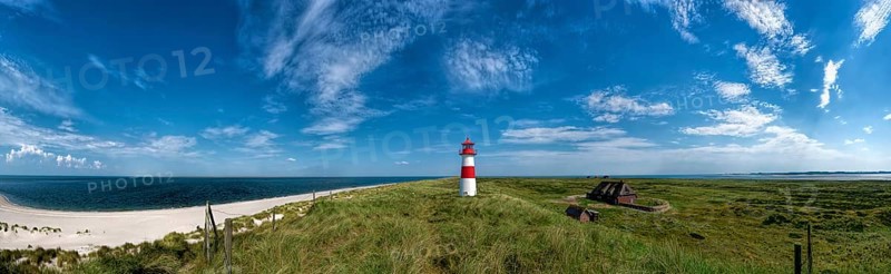 Beach panorama at the elbow with lighthouse