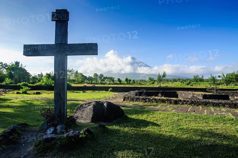 Christian cross before volcano Mayon