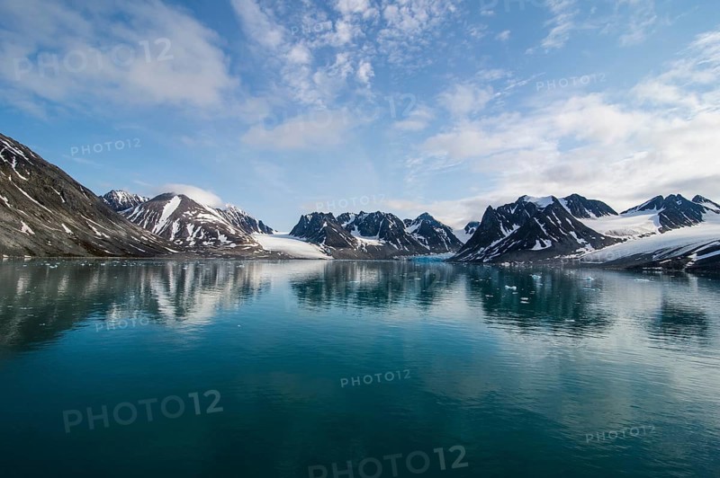 Mountains reflecting in the water in the Magdalenefjorden