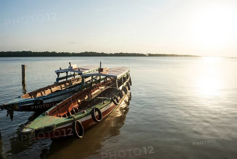 Boats at sunset on the Suriname river near Paramaribo