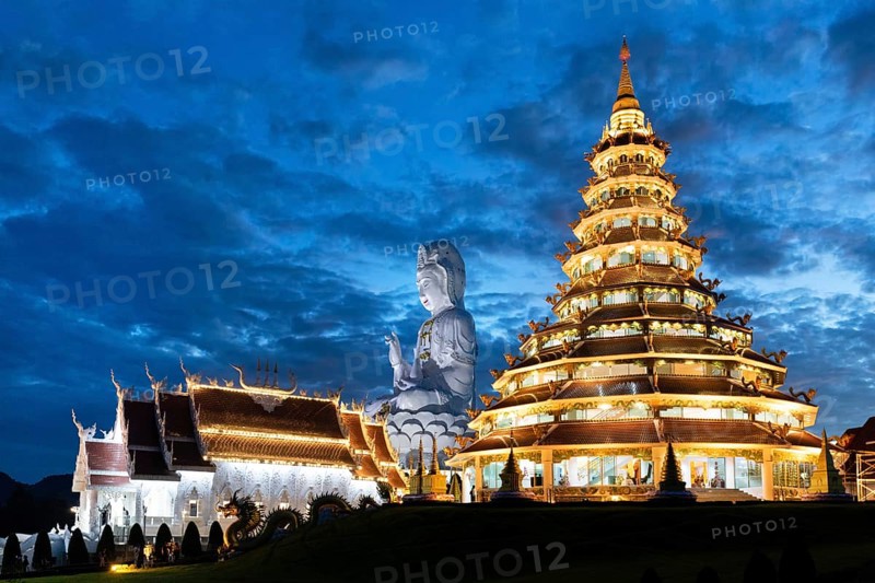 Nine-storey Chinese pagoda and chapel with huge Guan Yin statue at dusk