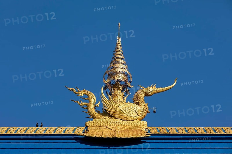 Golden decorated mythical phoenix figure on the roof of Wat Rong Seur Ten