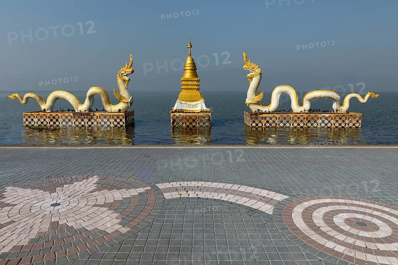 White Naga statues with golden Chedi on the shore of Lake Kwan Phayao