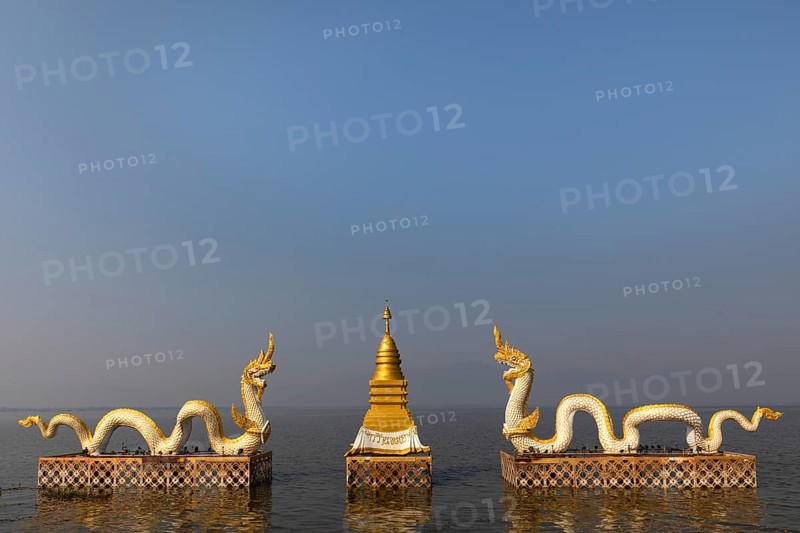White Naga statues with golden Chedi on the shore of Lake Kwan Phayao