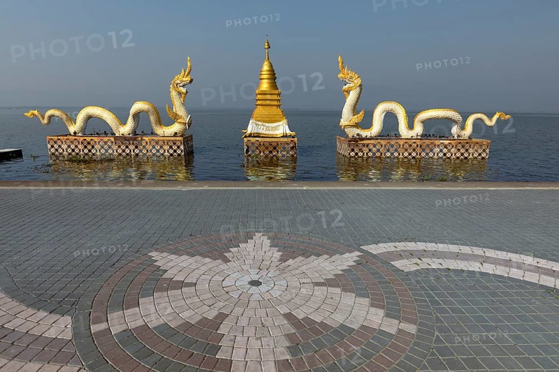 White Naga statues with golden Chedi on the shore of Lake Kwan Phayao