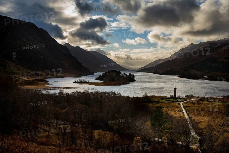 Loch Shiel with Glenfinnan Monument under cloudy sky