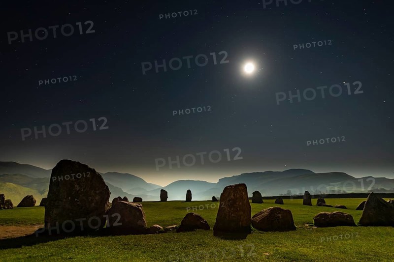 Stone circle at full moon with starry sky