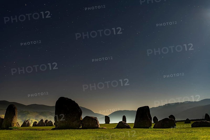 Stone circle at full moon with starry sky