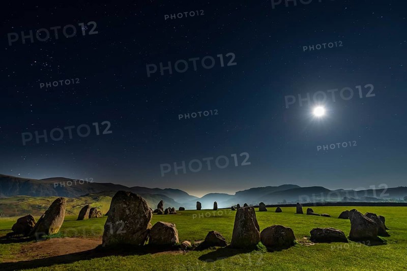 Stone circle at full moon with starry sky