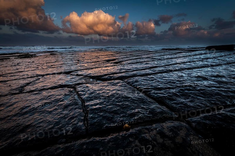 Coast with granite rocks washed by the sea in the evening light